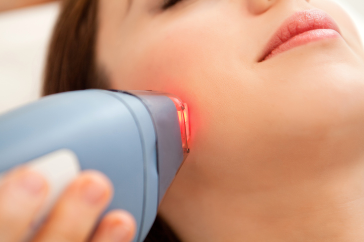 Woman receiving laser therapy.