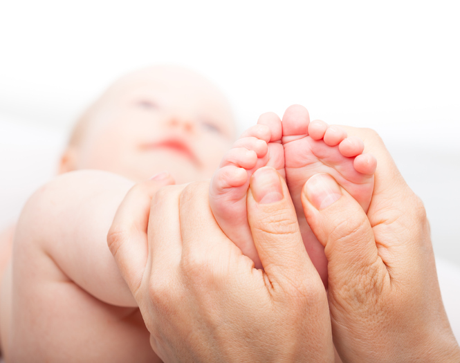 Pediatric dermatologist examining an infant.