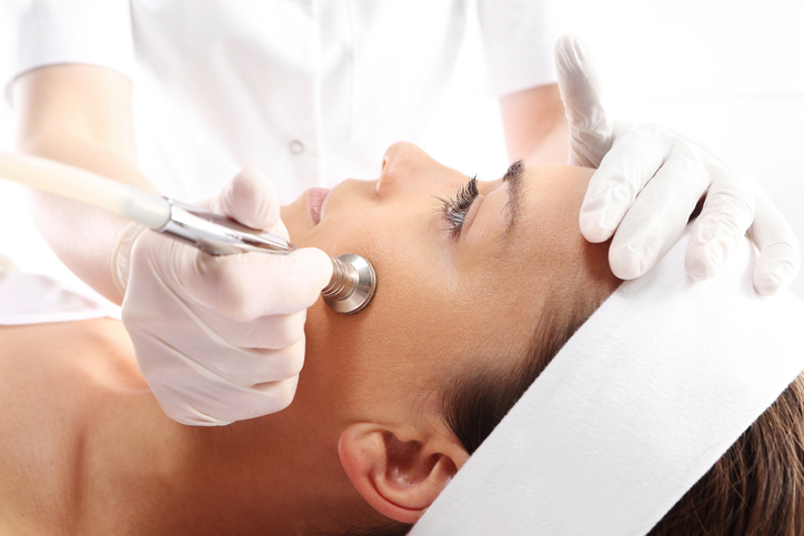 Relaxed woman during a microdermabrasion treatment.