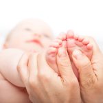 Pediatric dermatologist examining an infant.