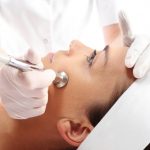 Relaxed woman during a microdermabrasion treatment.