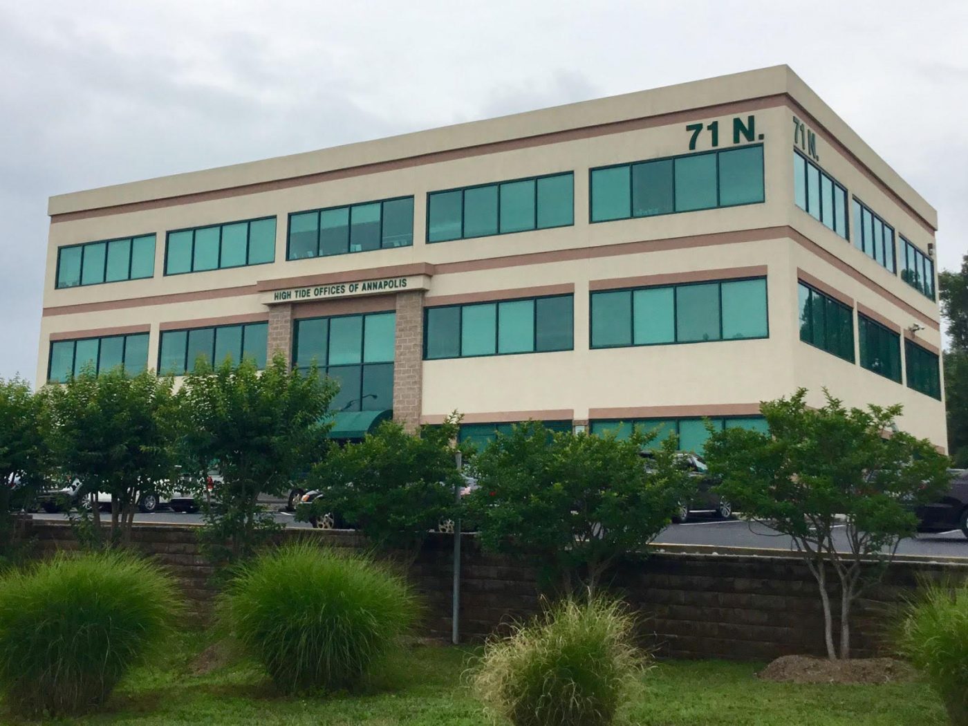 Three-story office building with green-tinted windows, labeled "High Tide Offices of Annapolis."