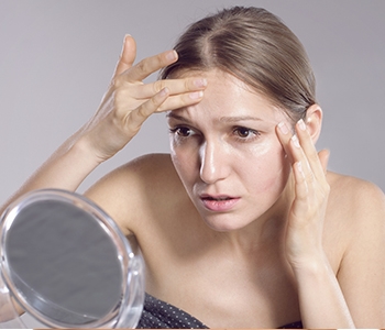 woman looking at mirror