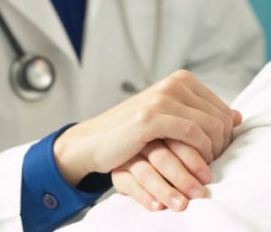 doctor holding patients hand