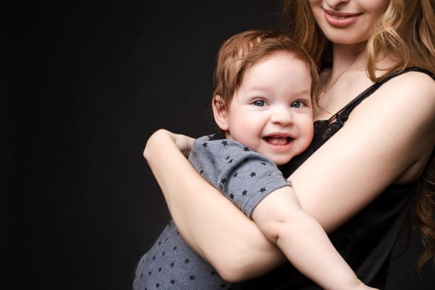 Mother holding baby with eczema