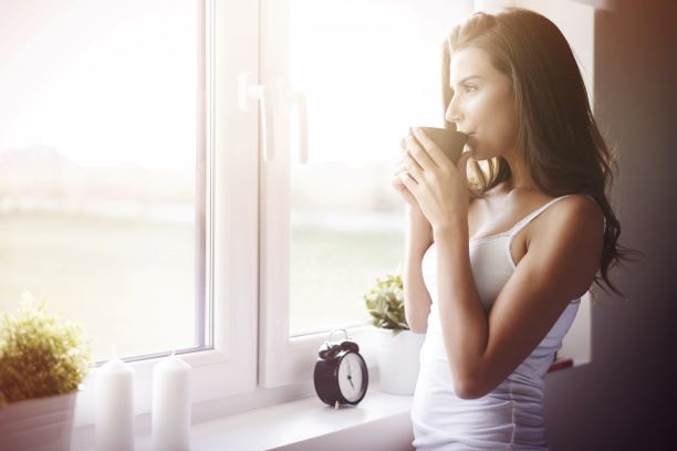 woman at home maintaining daily sunscreen use