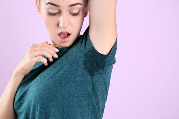 Young woman with axillary hyperhidrosis