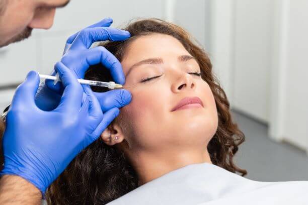 Woman receiving neurotoxin injections