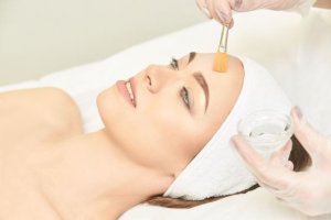 Woman receiving a chemical peel on face