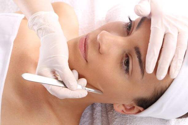 Woman receiving dermaplane procedure