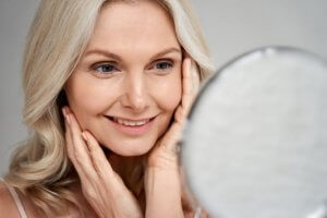 Mature woman using anti aging skin care routine