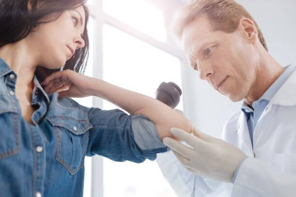 Woman being checked for melanoma