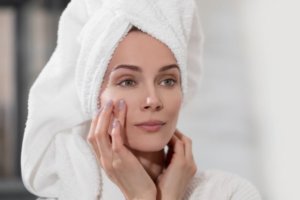 Woman examining skin texture