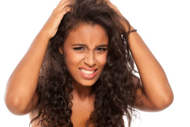 woman scratching scalp eczema