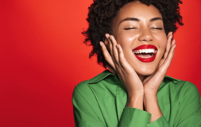 woman admiring holiday skincare routine