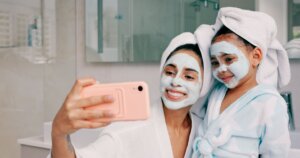 Mom and child taking selfie - skincare tips for busy moms