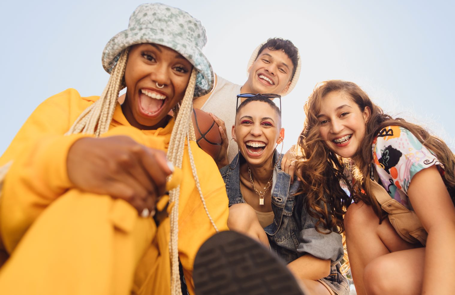 Skin Cancer in Millennials and Gen Z - group of Gen Z friends smiling on a sunny day