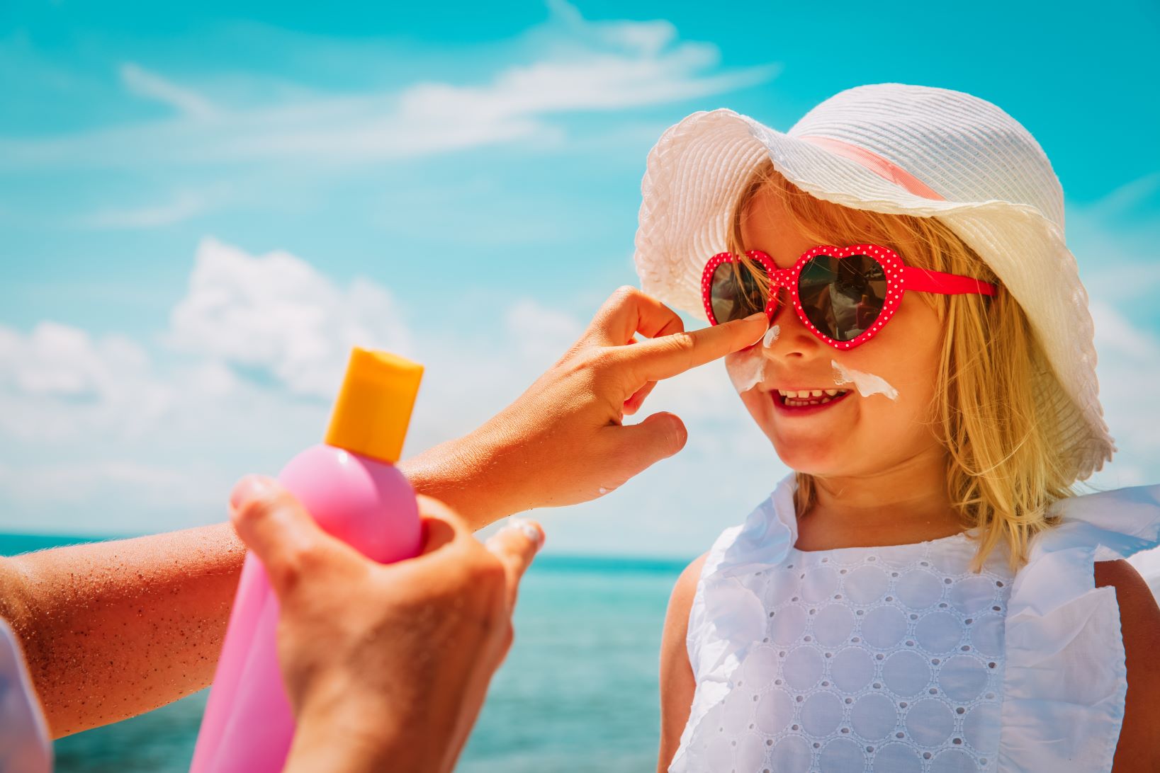 kids sunburn, child receiving sun protection for kids on a sunny day