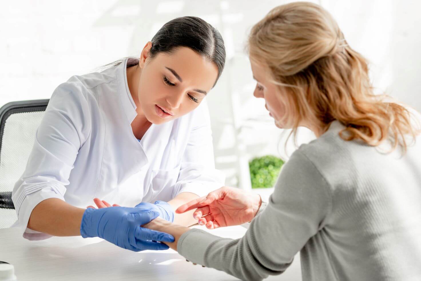 woman discussing viral and bacterial skin infections with dermatologist