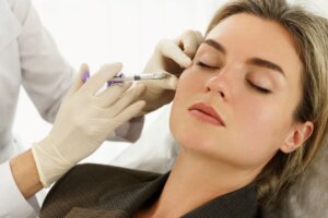 Woman receiving dermal fillers in her face