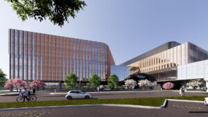 A modern architectural rendering of a large building complex with glass facades, trees, and a roadway.
